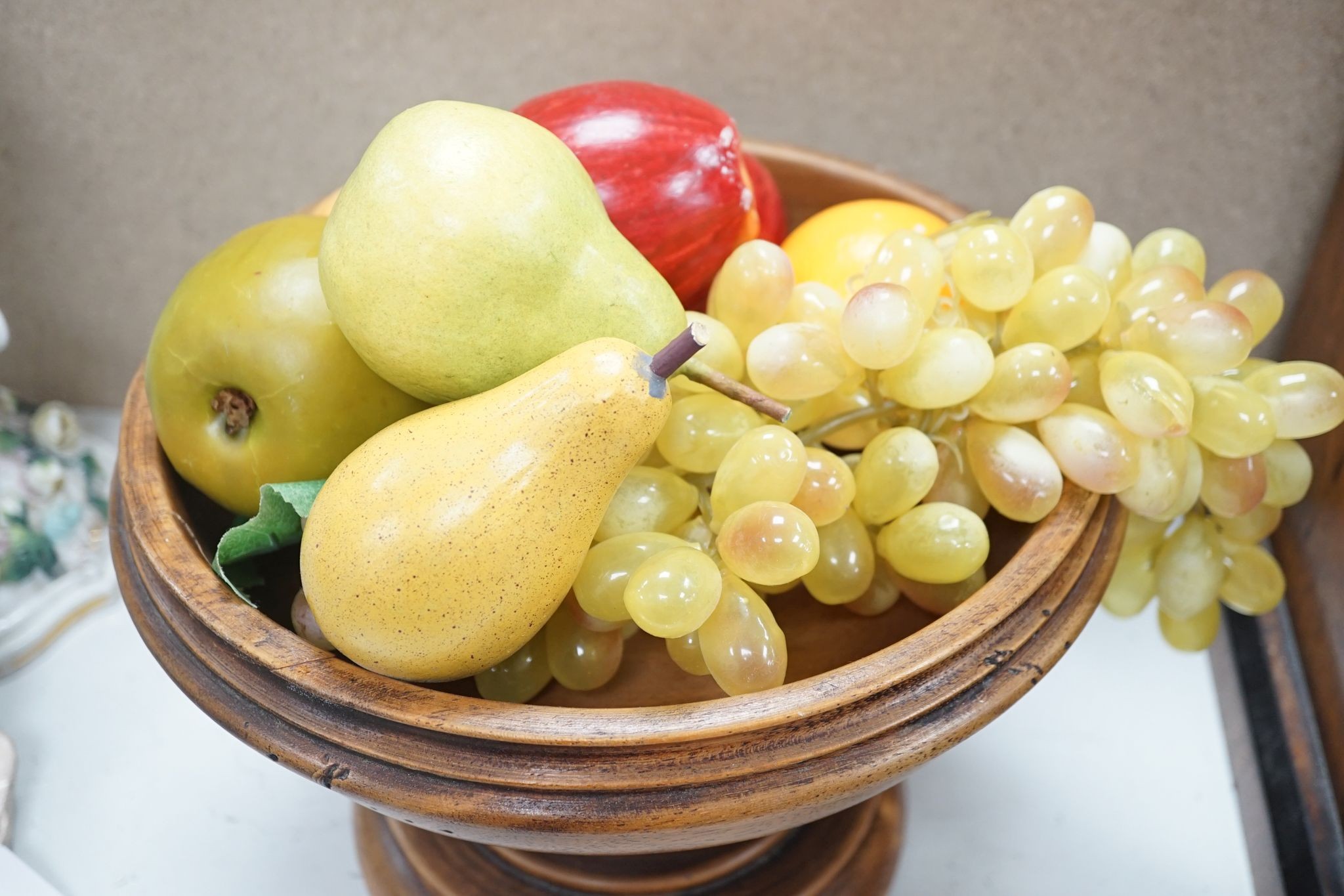 Faux fruit on a turned wood pedestal bowl